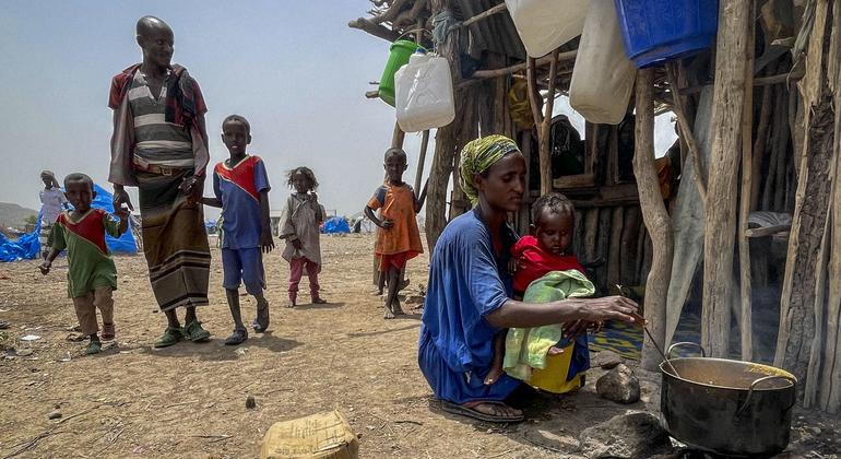 A displaced mother cooks for her family in Afar, Ethiopia.