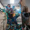 A worker sorts plastic for recycling at Dandora landfill in Nairobi, Kenya.