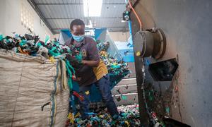 A worker sorts plastic for recycling at Dandora landfill in Nairobi, Kenya.