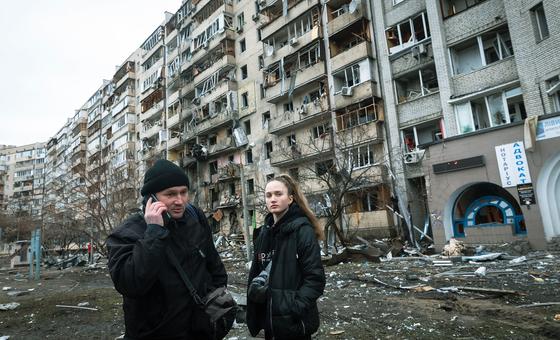 On 25 February 2022 in Kyiv, Ukraine, a man calls relatives, standing in front of an apartment building heavily damaged during ongoing military operations.