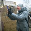 On 25 February 2022 in Kyiv, Ukraine, a resident photographs her apartment building, which was heavily damaged during ongoing military operations