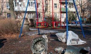 On 25 February 2022, spent pieces of a rocket lie next to a playground, with military operations ongoing in Kyiv, Ukraine.