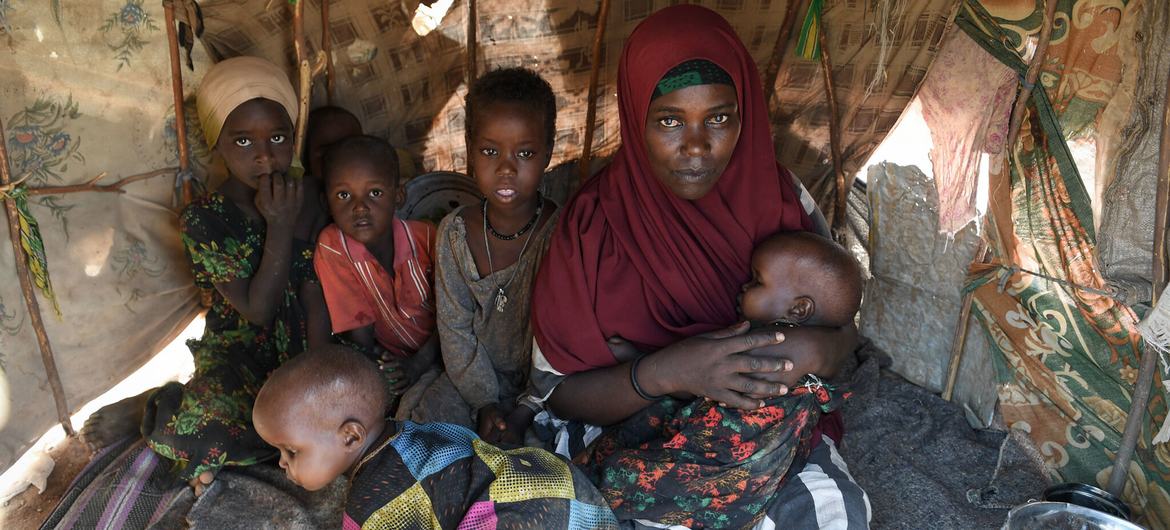 A mother and her five children inside their makeshift shelter at a camp for Internally Displaced Persons (IDPs) in Luuq, Somalia on 21 March 2022.