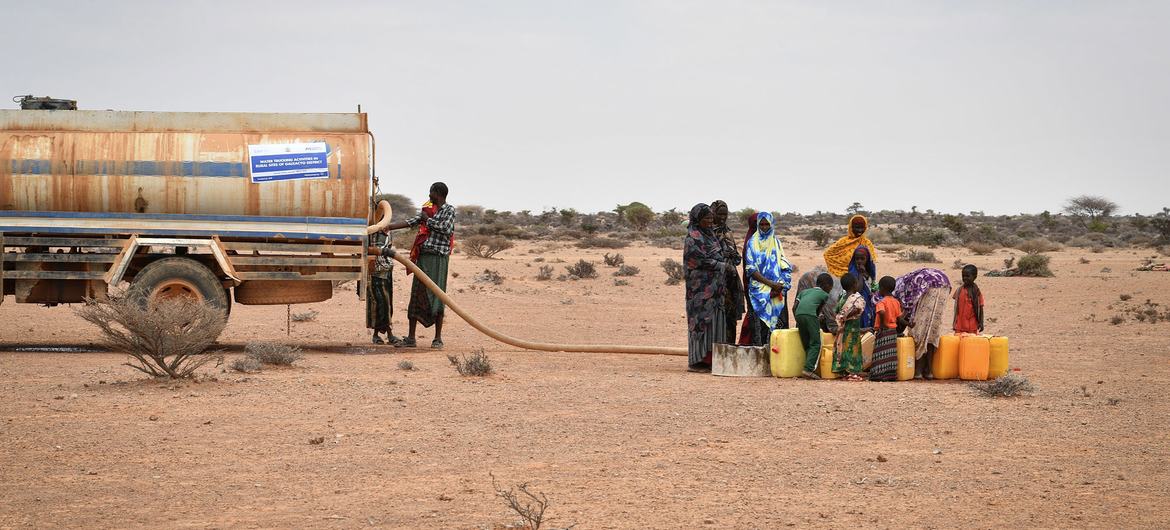 A group of women fetch water at a water trucking point in Kureyson village, Galkayo, Somalia on 23 March 2022.