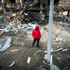 A man walks in front of a crater left by an explosion during escalating conflict in Kyiv, Ukraine.  