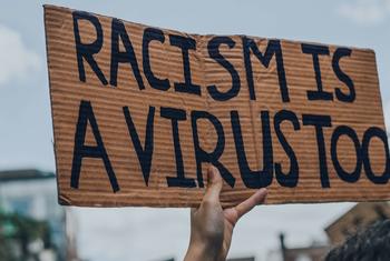 "Racism is a Virus" sign  at a Black Lives Matter protest in Montreal, Canada.