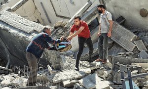 Possessions are salvaged from a damaged building in Gaza following Israeli strikes in May.