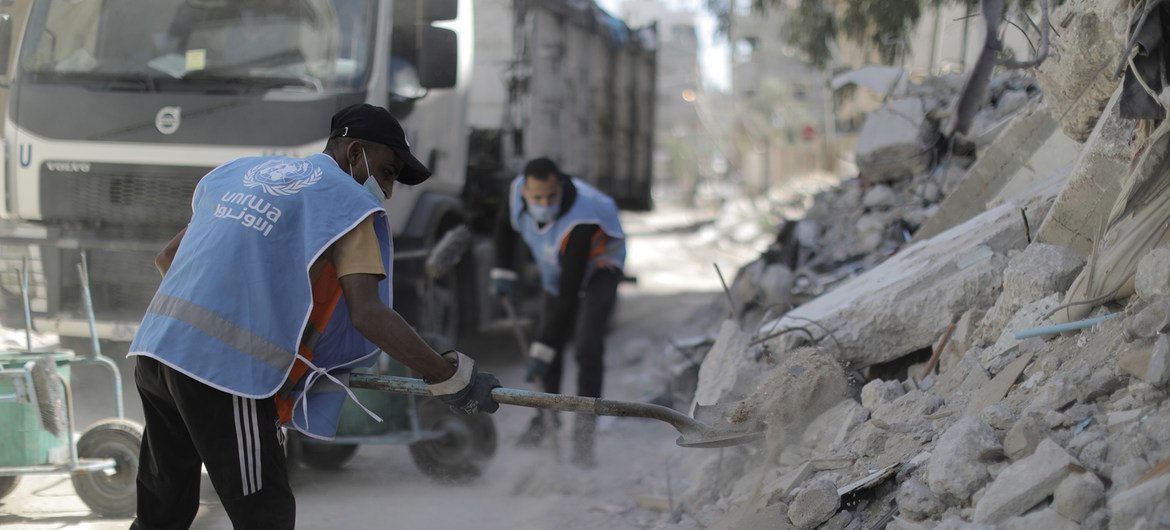 عمال الأونروا يعملون على إزالة الأنقاض في غزة.