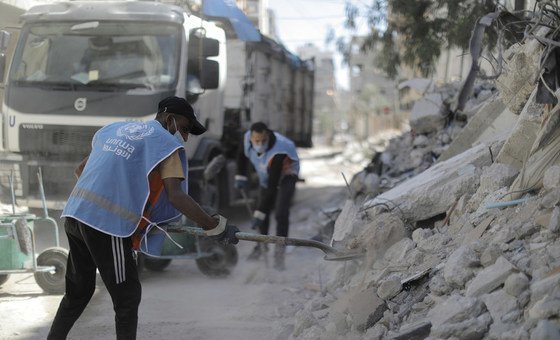 UNRWA sanitation workers clear streets of rubble in Gaza.