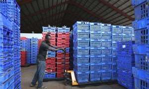 A worker moves stock in a factory producing fruit drinks in Accra, Ghana. (file)