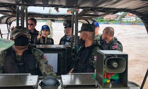 The UN Resident Coordinator in Thailand, Gita Sabharwal (centre background) joins a patrol on the  Mekong River. 