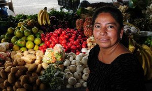 A woman attends her produce post in a market in zone 3, Guatemala City, Guatemala. (August 2009)