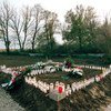 Candles and wreaths mark a mass grave site at Ovcara, Croatia, where approximately 200 civilians were massacred in 1994.