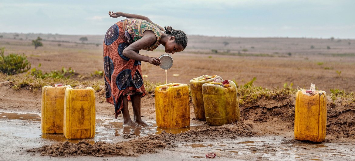 A woman collects rain water on a road in drought-stricken southern Madagascar.