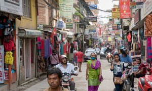 People walk down a street of shops in Kathmandu, Nepal. (file)