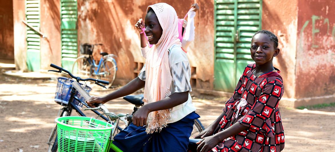 Children ride a bike in Fada, Burkina Faso.