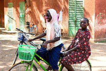 Children ride a bike in Fada, Burkina Faso.