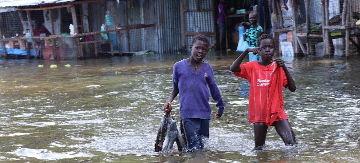 Children walk in flood waters in Jonglei state, South Sudan.
