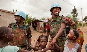 Malawian peacekeepers serving with the United Nations Operation in Côte d’Ivoire (UNOCI) greet children while on patrol in August 2012.