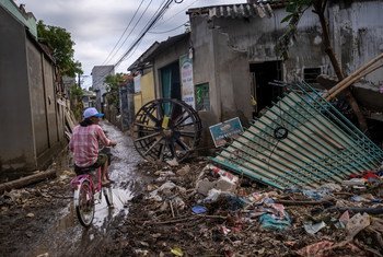 A man rides past a house destroyed by typhoons in Le Thuy district, Quang Binh province, central Viet Nam