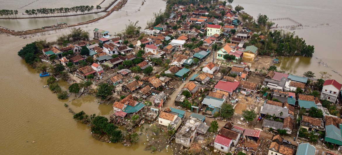 An aerial photograph showing houses destroyed and submerged in flood waters caused by the typhoon in Le Thuy district, Quang Binh province, central Viet Nam.