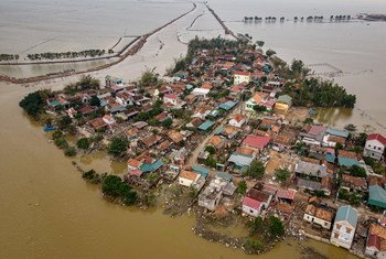 An aerial photograph showing houses destroyed and submerged in flood waters caused by the typhoon in Le Thuy district, Quang Binh province, central Viet Nam.