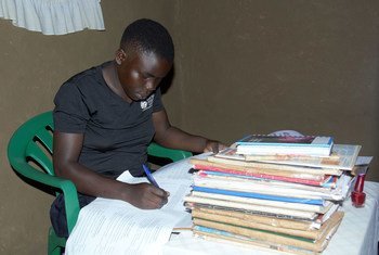 A teenage student studies at home during the COVID-19 lockdown in Uganda.