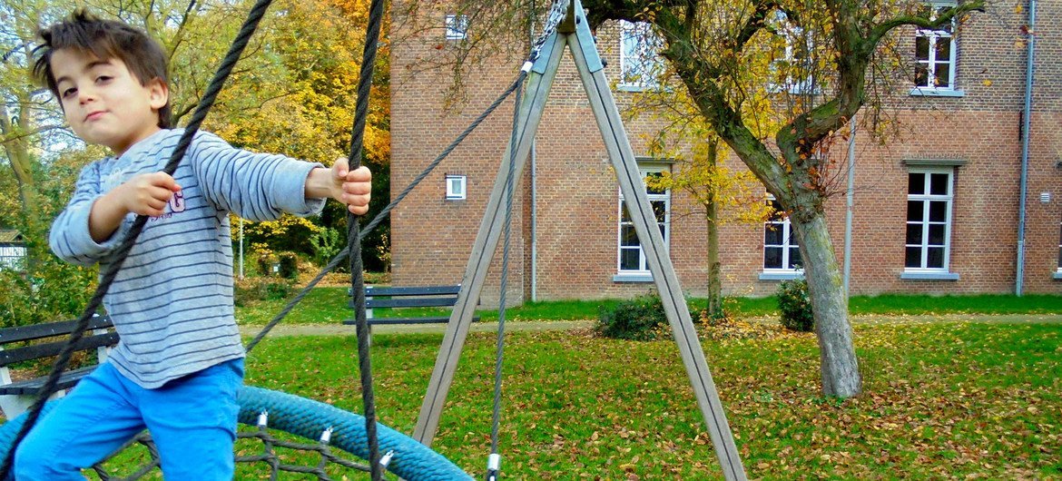A boy plays in the playground of an asylum seeking centre in Baexem in the Netherlands.