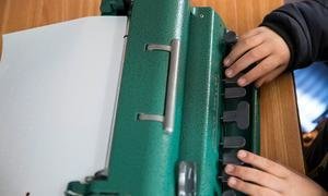 A seven-year-old Palestinian boy, who is blind, uses a braille device in class, at a school in Hebron in the West Bank.