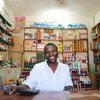 IOM helped Mohammed Ahmed to set up a shop in Omduram market, near Khartoum, Sudan. The initiative involves the use of mobile money to buy goods