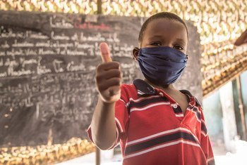 An eight-year-old child  in Nouakchott, Mauritania, gives a thumbs-up after an awareness session on preventing COVID-19.