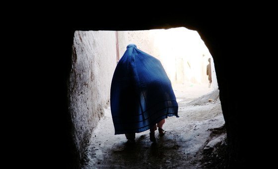  An Afghan pistillate   covers a kid  nether  her Borqa portion    passing done  a passageway  successful  Herat, Afghanistan.