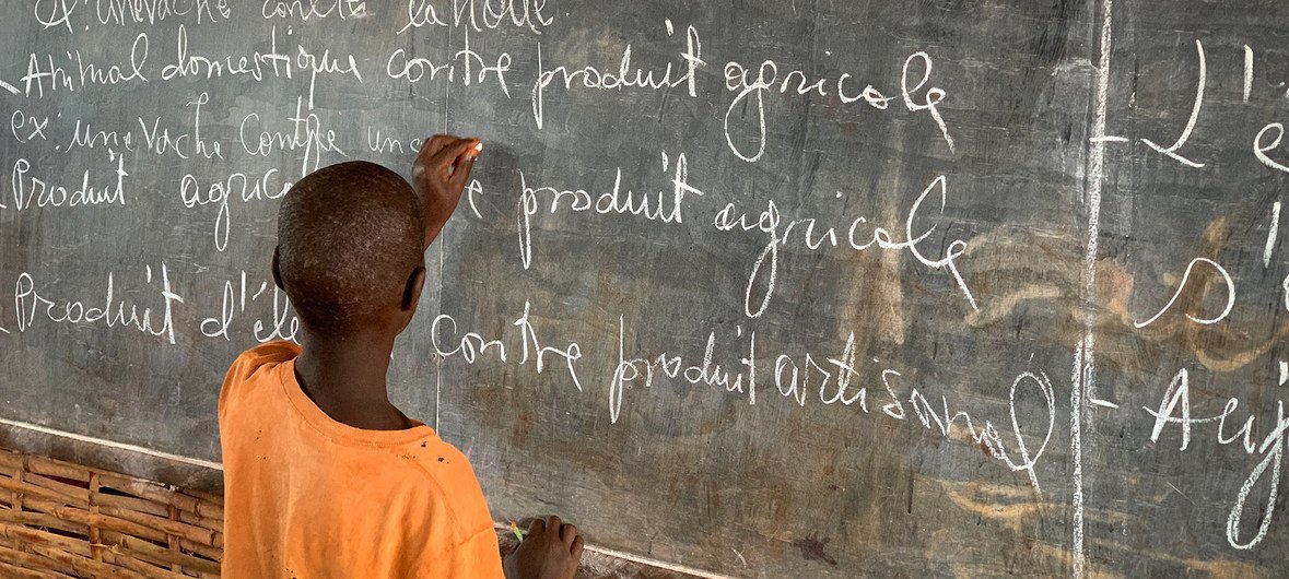 A young Burundian refugee completes an exercise on a blackboard at Jugudi Primary School in Nyarugusu Refugee Camp, Kigoma Province, north-west Tanzania. (February 2019)
