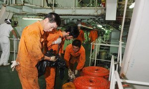 Seafarers work in the engine room of a Chinese registered ship in the Port of Genoa in Italy.