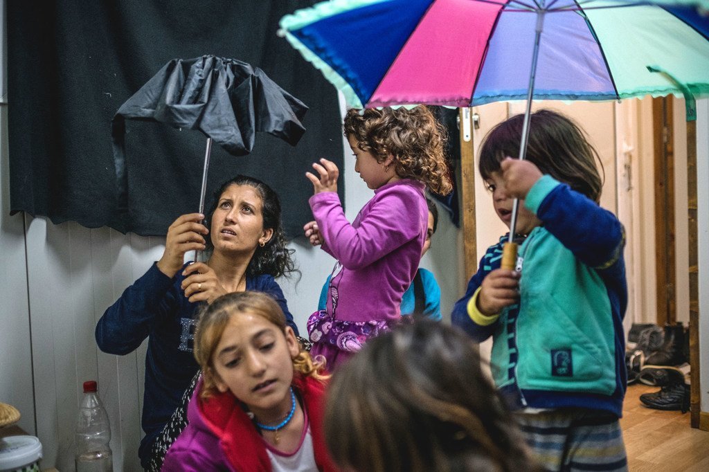 Yasidi family , sit inside their room at Skaramagas refugee camp, in the port area of northern Athens, Greece. (file)