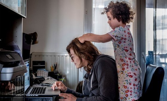 Anne-Lise, a journalist teleworking for TV channel Euronews in Lyon, France, with 3-year-old daughter Violette keeping close.