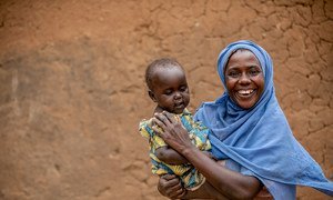 A HIV-positive woman and her baby take their medication on a daily basis at their home in Mbarara, western Uganda.