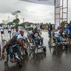 在利比里亚蒙罗维亚市中心举行的10公里小型残疾人马拉松比赛开始时，利比里亚残疾运动员推着轮椅前行（档案照片）。