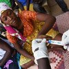 In Ndjamena, Chad, a seventeen-year-old girl smiles when she learns she's HIV negative. 
