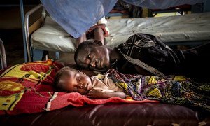A father rests with his son at the Bangui Paediatric hospital in the capital of the Central African Republic.