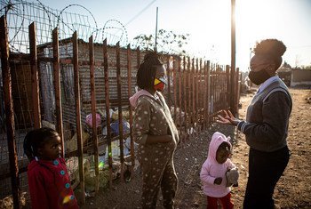 A teenage activist speaks with a young girl in an informal settlement on the outskirts of Johannesburg, South Africa (file photo).