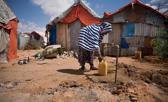 A young girl collects water in Mogadishu, Somalia.