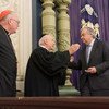 Secretary-General António Guterres (right) is greeted by Arthur Schneier, Senior Rabbi at Park East Synagogue, alongside Cardinal Timothy Dolan, at a 2018 interfaith ceremony following the deadly mass shooting at the Tree of Life synagogue in Pittsburgh.