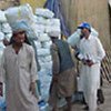 Relief workers unload food aid