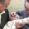 SRSG Brahimi assists in immunizing of Afghan child