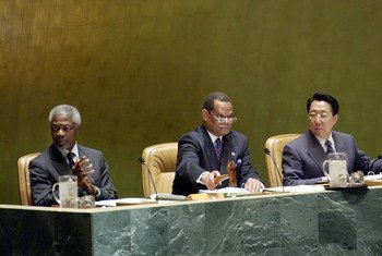 New General Assembly President Julian Robert Hunte of St. Lucia opens the 58th session with a strike of the gavel. At his left is Secretary-General Kofi Annan and right is Chen Jian, Under-Secretary-General of Department of General Assembly Affairs and Co