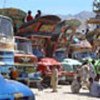 Trucks wait for newly-returned families at Pul-i-Charki