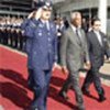 Kofi Annan (centre) greeted by honour guard