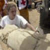 Jolie helps refugees load their few belongings onto a truck