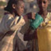 A girl pours water, camp in Eritrea